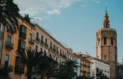 a building with a clock tower and a church at Travel Habitat Santo Domingo Loft in Valencia