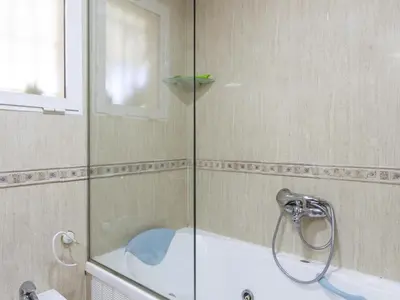 a shower with a glass door in a bathroom at Winahost Villa Unión in Puebla de Vallbona