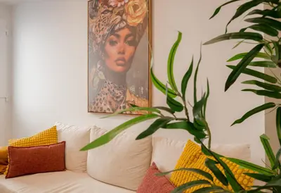 a painting on the wall above a white couch at Casa Estrellita Boutique Apartment in Valencia