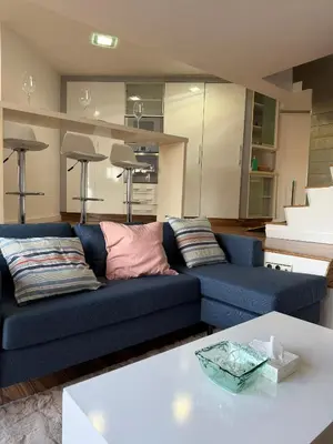 a living room with a blue couch and a table at Malvarrosa Penthouse 4 rooms, suite, terrace and balcony in Valencia