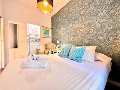 a bedroom with a large bed with towels on it at Padre Anton seasonal apartment in Valencia