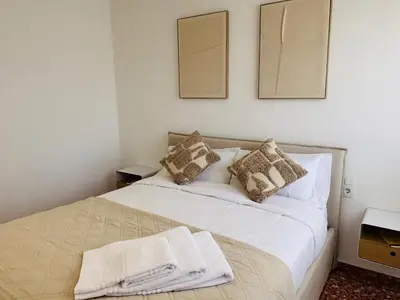 a bedroom with a bed with white sheets and pillows at Cosy Flat Catarroja in Catarroja