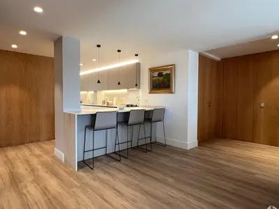 a kitchen with a counter and a bar with stools at Bright spacious luxury apartment in Valencia