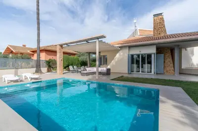 a swimming pool in the backyard of a house at Villa Azahar - Mediterranean Retreat in Benifayó