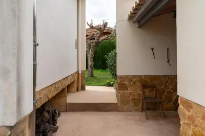an entrance to a house with a stone wall at Villa Azahar - Mediterranean Retreat in Benifayó