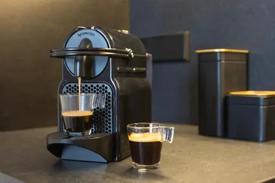 a coffee maker and a glass of coffee on a counter at Borrull Historic Center Premiere in Valencia