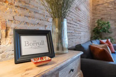a picture frame sitting on a table with a vase at Borrull Historic Center Premiere in Valencia