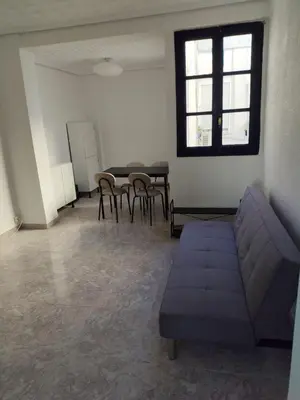 a living room with a couch and a table and chairs at Carmen & Alejandro Home in Valencia