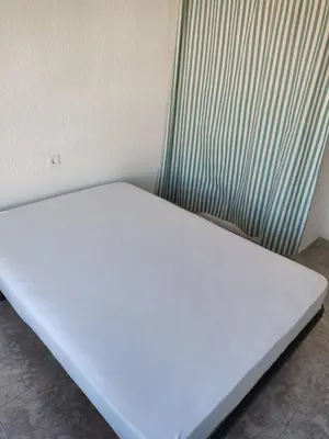 a bed in a room next to a radiator at Carmen & Alejandro Home in Valencia