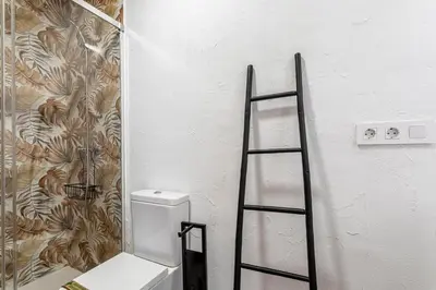 a bathroom with a ladder next to a toilet at GuestReady - Traditional House near Malvarrosa in Valencia
