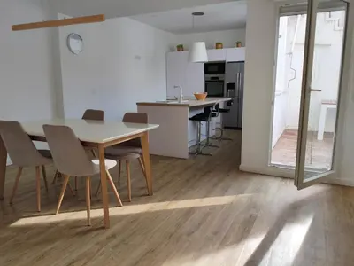 a kitchen and dining room with a table and chairs at Valencia City Premium Terrace Apartment in Valencia