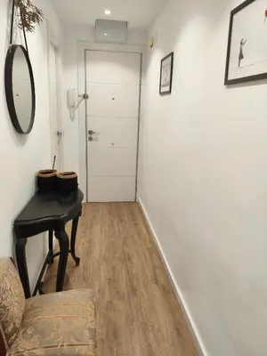 a hallway with a table and a chair and a door at Valencia City Premium Terrace Apartment in Valencia