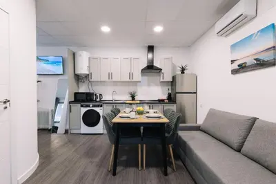a living room with a couch and a table at Modern Stay Near Benicalap Park in Valencia
