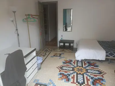 a bedroom with a bed and a dresser at Habitación Grande Ruzafa Centro in Valencia