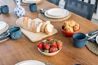 a table with strawberries and croissants and a bowl of fruit at Casa Rosa Longterm Living and Workspace in Monserrat