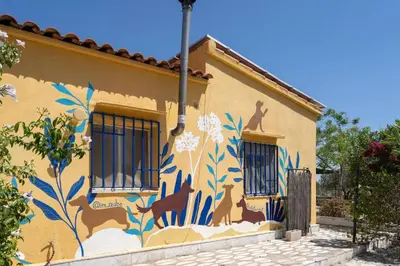 a building with a mural of animals on it at Casa Rosa Longterm Living and Workspace in Monserrat
