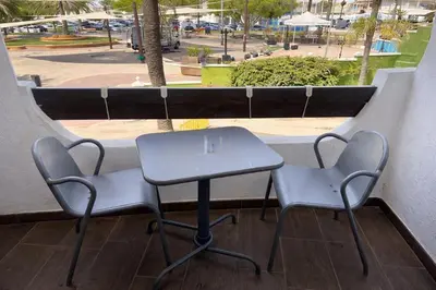 a table and two chairs sitting on a balcony at Terraced House MARIELISA in Puebla de Farnals