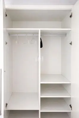 a white walk in closet with white shelves at Terraced House MARIELISA in Puebla de Farnals
