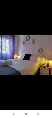 a bedroom with a white bed and a window at Valencia city in Valencia