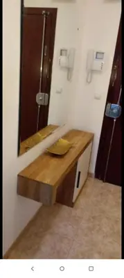 a bathroom with a wooden sink and a mirror at Valencia city in Valencia