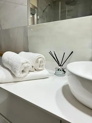 a bathroom with a sink and towels on a counter at Heart of Valencia in Valencia