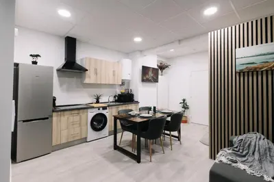 a kitchen and dining room with a table and chairs at N4 Comfortable & bright apartament Park Benicalap in Valencia