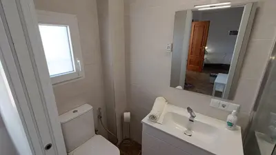 a bathroom with a toilet and a sink and a mirror at Magnifico y moderno estudio bien ubicado in Valencia