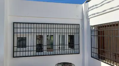 a white building with a gate on it at Magnifico y moderno estudio bien ubicado in Valencia