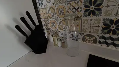 a kitchen counter with utensils and a wall with tiles at Magnifico y moderno estudio bien ubicado in Valencia