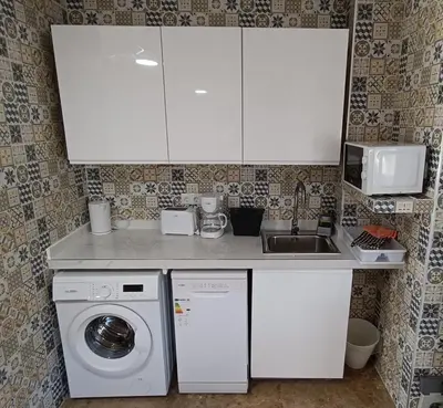 a kitchen with a washing machine and a sink at Magnifico y moderno estudio bien ubicado in Valencia