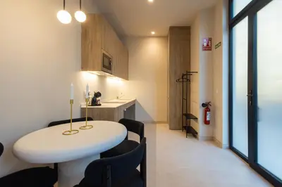 a room with a white table and some chairs at Loft Valencia - B 1-6 Smart Access & Urban Calm in Valencia