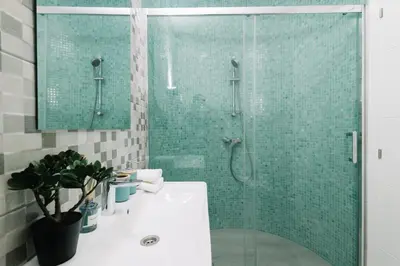 a bathroom with a glass shower and a sink at N2 Bright & Comfortable Apartment Benicalap in Valencia