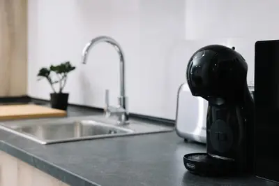 a coffee maker sitting on a counter next to a kitchen sink at N2 Bright & Comfortable Apartment Benicalap in Valencia