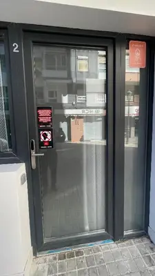 a glass door of a building with a sign on it at N2 Bright & Comfortable Apartment Benicalap in Valencia