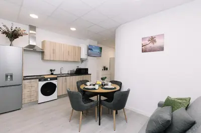 a kitchen and dining room with a table and chairs at N3 Bright and Cosy apartament Park Benicalap N3 in Valencia