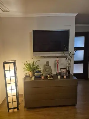 a living room with a tv on top of a dresser at Acogedor y exótico hogar con piscina privada in Rafelguaraf