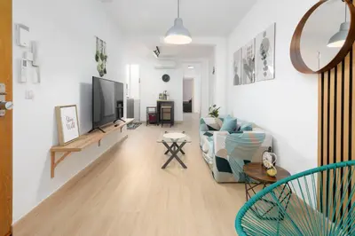 a living room with a couch and a tv at Modern 2BR in Beautiful Burriana in Burriana