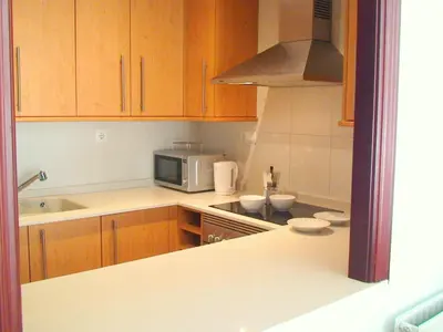 a kitchen with wooden cabinets and a microwave at Mestalla Silence in Valencia