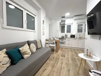 a living room with a couch and a kitchen at Loft Valencia TR28 - Ground & Arts Connected in Valencia