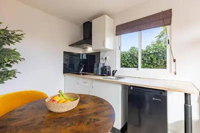 a kitchen with a wooden table and a bowl of fruit at Tiny House Long-term remote work near Valencia in Monserrat