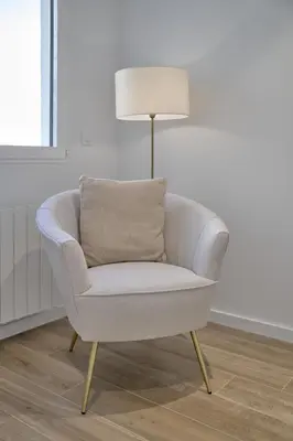 a white chair in a living room with a lamp at Luxury Romantic Apartment Mestalla by Virkin Suites in Valencia