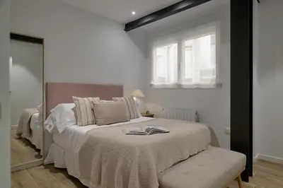 a bedroom with a bed with a book on it at Luxury Romantic Apartment Mestalla by Virkin Suites in Valencia