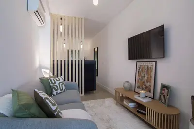 a living room with a couch and a flat screen tv at NOMAD Viveros 02 in Valencia