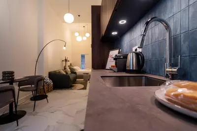 a kitchen with a sink and a living room at Studio 03 - Les artes in Valencia
