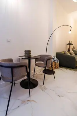a living room with a table and chairs and a couch at Studio 03 - Les artes in Valencia
