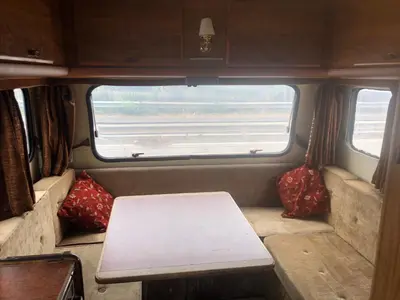 a small table in the back of a train car at Autocaravana in Port Saplaya