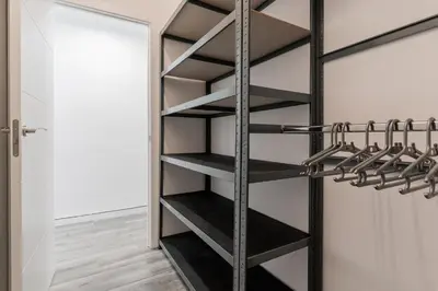 a walk in closet with black shelves at Modern 2BR Apartment with Terrace in Valencia in Valencia