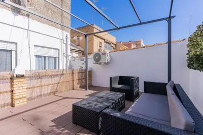 an outdoor patio with a couch and a heater at Modern 2BR Apartment with Terrace in Valencia in Valencia