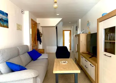 a living room with a couch and a tv at Casa Pera in Chilches