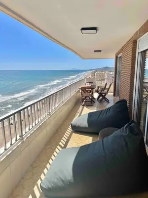 a balcony with pillows and a view of the ocean at Triton in Mareny Blau